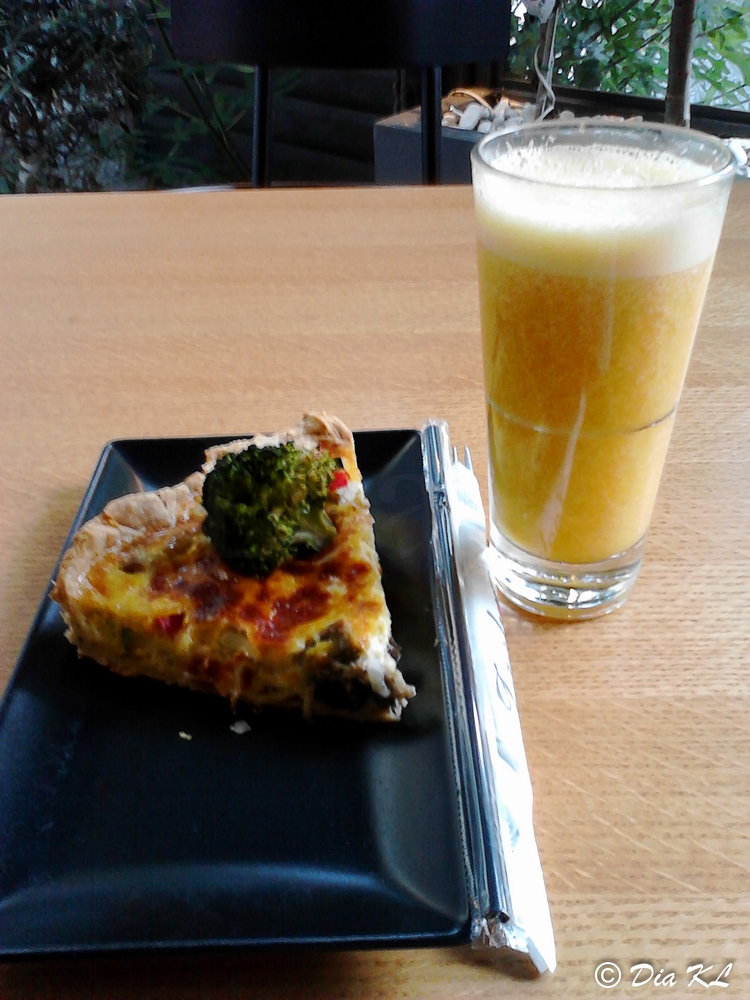 Fresh orange juice and a vegetarian quiche pie.